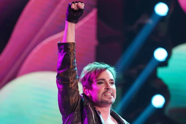 Foto colorida de Johnny Hooker com o braço levantado - Metrópoles