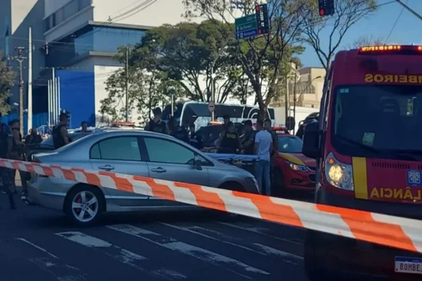 Imagem colorida de viatura e carro parados com cordão isolante na frente - Metrópoles