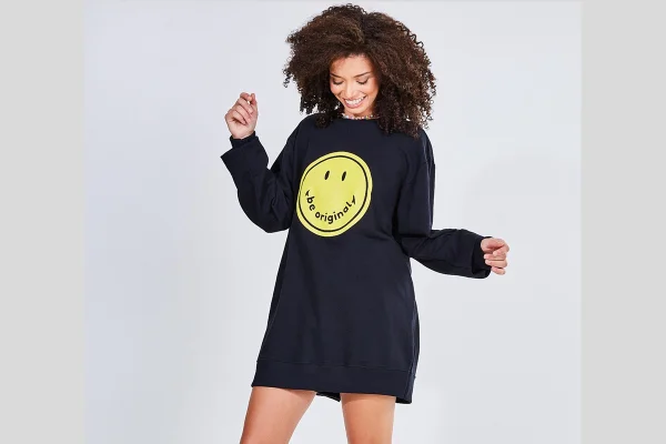 Modelo posa com moletom preto de smiley
