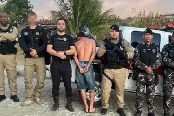 Imagem colorida de policiais com homem algemado