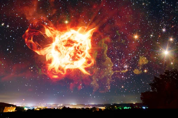 Ilustração colorida de estrela que explodiu no céu, transmitindo uma luz vermelha sobre uma cidade -Metrópoles.