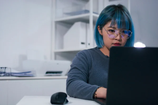Mulher focada escrevendo em computador - Metrópoles