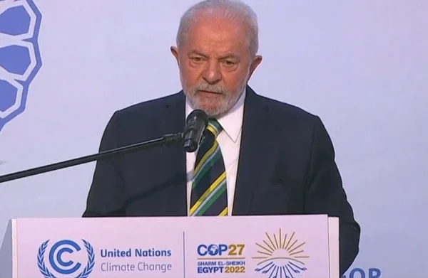 O presidente eleito Lula discursa em púlpito na COP27, no Egito. Ele fala diante de microfone - Metrópoles