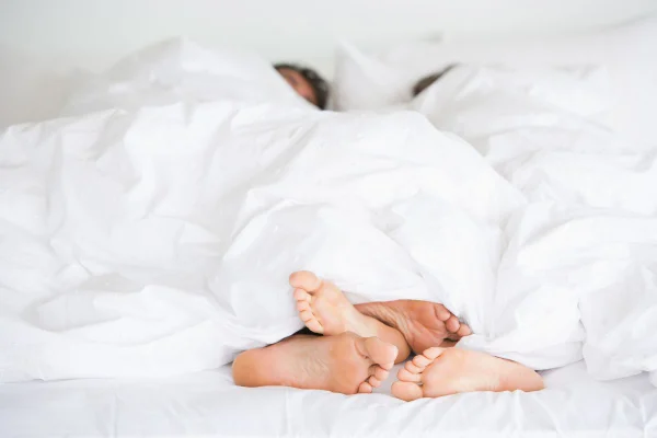 imagem colorida de dois pés em um cama