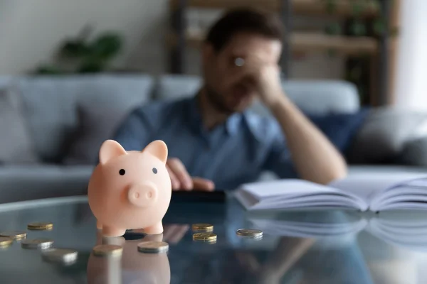 Foto colorida de homem se sentindo estressado calculando gastos - Ansiedade financeira: o que é, sintomas e como lidar com a condição - Metrópoles