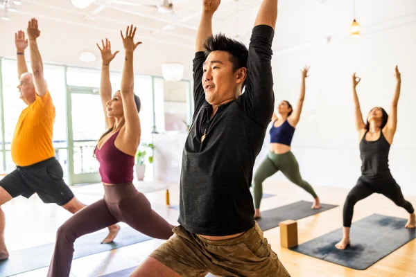 Pessoas fazendo aula de yoga em grupo - 5 crenças sobre o câncer que ainda atrapalham o tratamento - Metrópoles