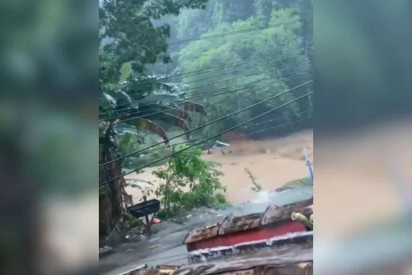 Imagem colorida mostra rua alagada em São Sebastião durante forte chuva - Metrópoles