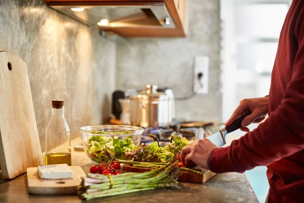 Foto colorida de pessoa preparando alimentos em casa - Nutricionista lista 7 maneiras eficazes de ajudar o seu intestino - Metrópoles