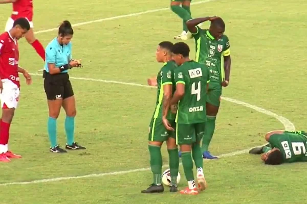 Juíza anota cartão amarelo enquanto jogador do Lagarto fica no chão, em partida pela Série D contra o Sergipe