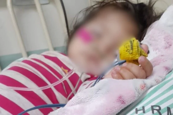 Foto colorida de Maytê, de apenas 1 ano, internada. rosto da crainaça está borrado bebê - Metrópoles