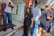 Vendedora mostra desnível e fachada quebrada na entrada de loja Vendedora mostra desnível e fachada quebrada na entrada de loja
