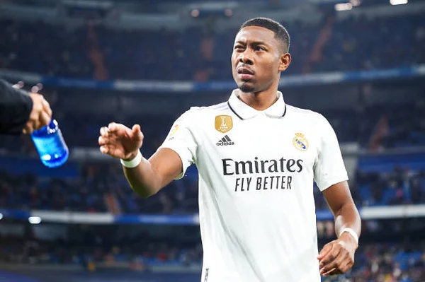 Imagem mostra jogador Alaba, do Real Madrid, recebendo uma garrafa - Metrópoles