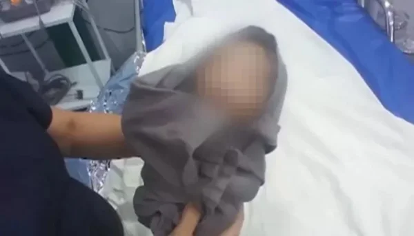 foto de uma pessoa segurando um bebê com o rosto desfocado