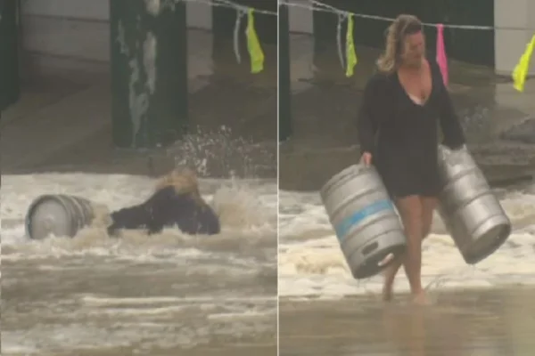 Mulher se arrisca em tempestade e enchente para salvar barris de cerveja