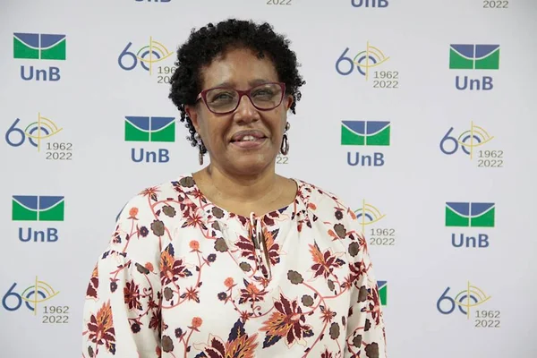 mulher negra de cabelo curto e com óculos