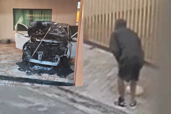 Foto colorida de homem de preto se agachando em frente garagem de casa; ele havia sido beneficiado pela saidinha e ateou fogo em carro - Metrópoles
