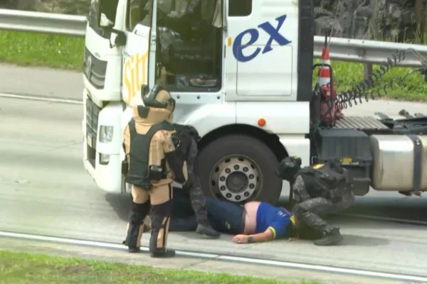 Imagem colorida mostra momento em que caminhoneiro é resgatado após possível sequestro no rodoanel. Metrópoles