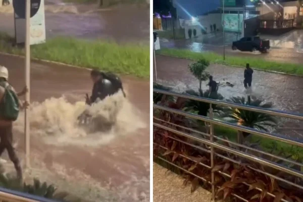 Imagem colorida de motoqueiro tentando salvar moto da enxurrada - Metrópoles