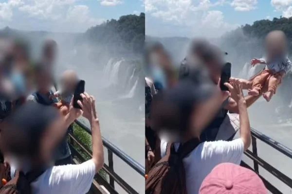 Homem segura bebê fora da área de segurança em mirante