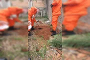 Bombeiros desenterrando o corpo Bombeiros desenterrando o corpo