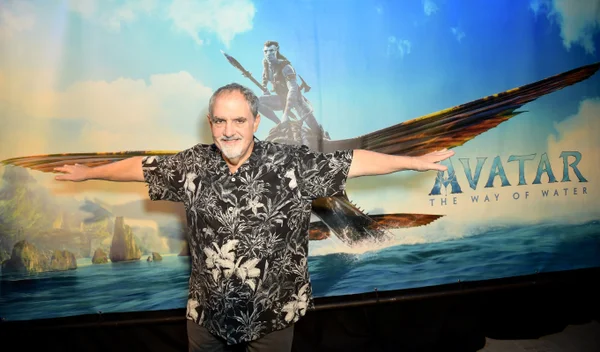 Fotografia colorida de um homem com um cartaz de Avatar