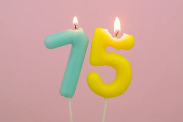 Foto colorida de fundo rosa com numerais 7 e 5 de cor azul e amarela - Metrópoles.