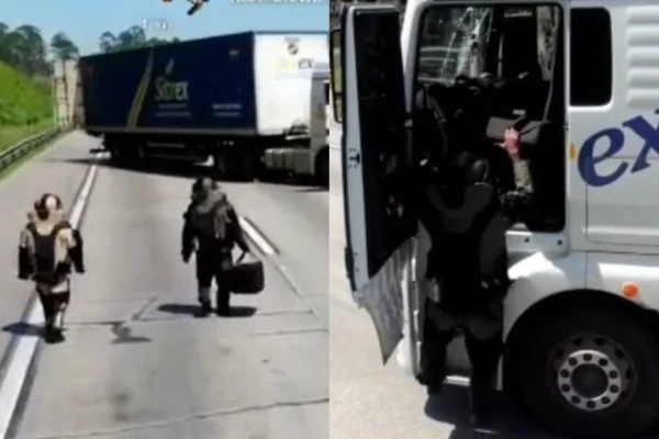 Agentes com trajes antibomba se aproximam de caminhão atravessado no Rodoanel - Metrópoles