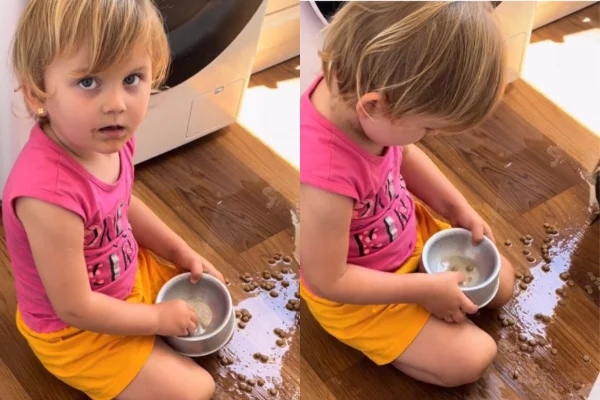 Foto colorida de uma menina comendo ração de cachorro - Metrópoles