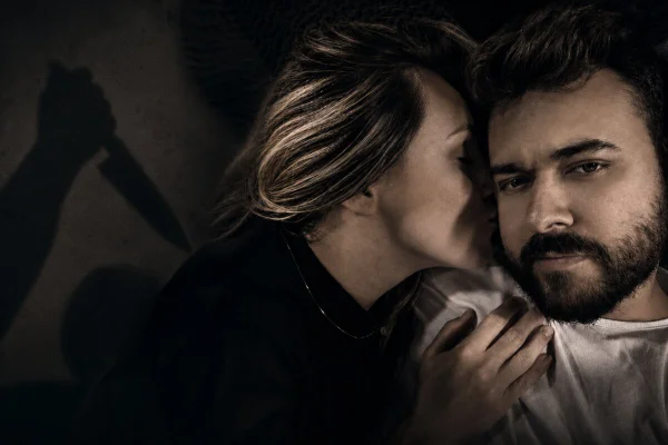 Arte gráfica de mulher beijando homem sério e trás dela mão fantasmagórica a ameaça - Metrópoles