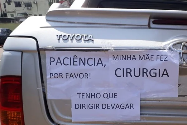 Filha com mãe operada põe cartaz no carro para explicar lentidão