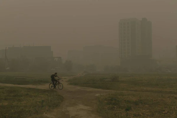 SAKHA, RUSSIA - AUGUST 13: Blanket of smog covers the city as air pollution increases due to the ongoing wildfires around the village of Kharyyalakh in Sakha, Russia on August 13, 2021. (Photo by Ivan Nikiforov/Anadolu Agency via Getty Images)