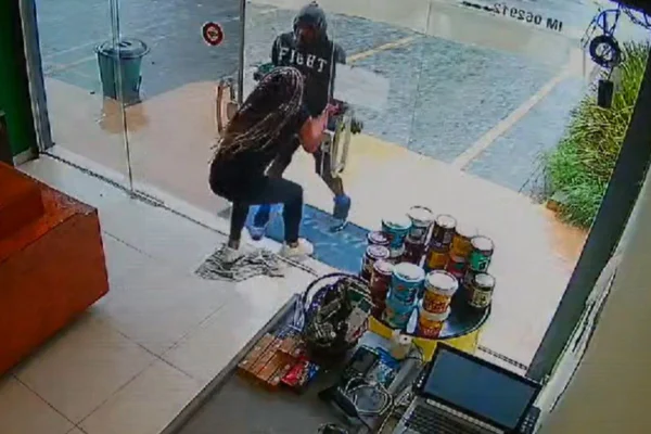 Imagem estática de câmera de segurança mostra embate entre homem e mulher na porta de loja