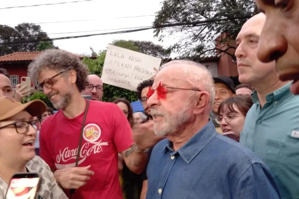 Imagens coloridas mostram o presidente Lula cumprimentando apoiadores na porta de casa