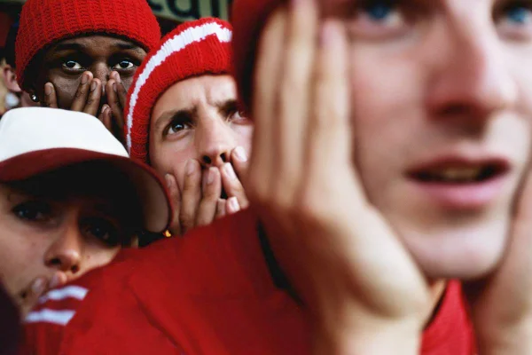 Imagem mostra pessoas ansiosas vendo um jogo de futebol - Metrópoles