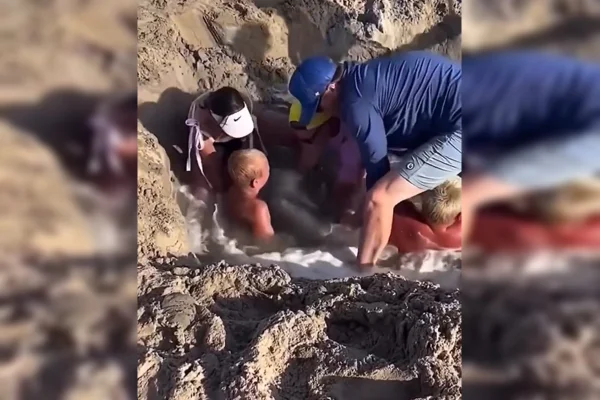 Imagem colorida de pessoas tentando tirar uma criança de um buraco