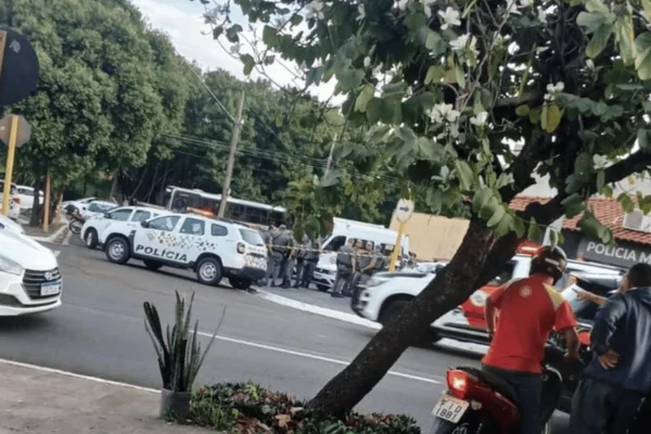 Imagem colorida de uma rua com inúmeras viaturas no local onde o homem foi baleado por invadir a base policial - Metrópoles