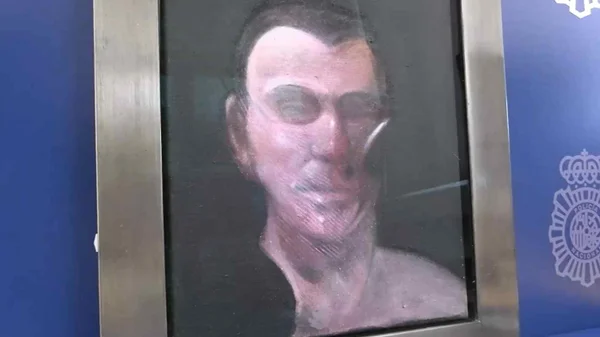 Imagem colorida. Quadro com a face de um homem