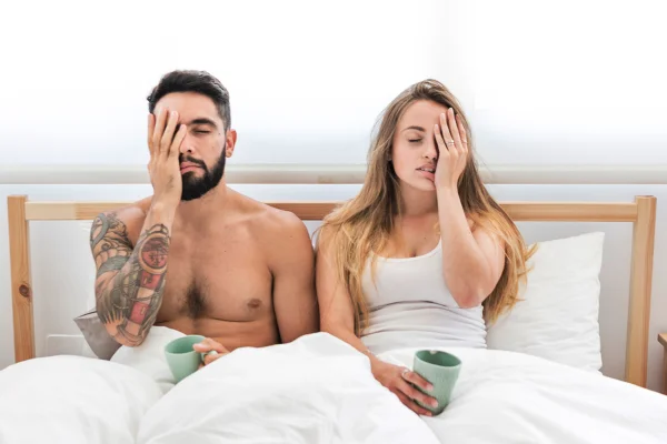 Foto colorida de casal com semblante de irritação