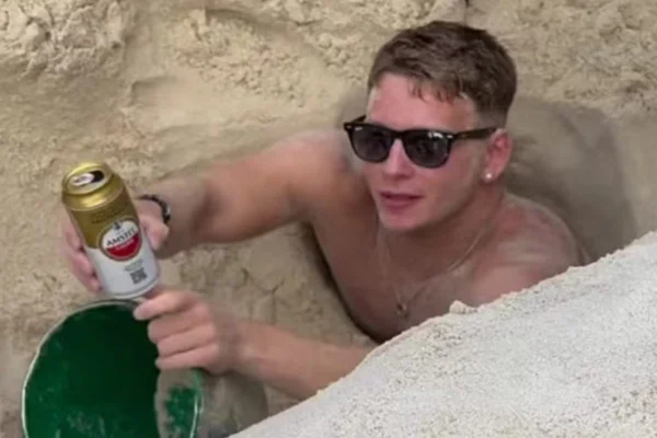 Imagem colorida de turista inglês que ficou preso na areia da praia de Copacabana, no Rio de Janeiro - Metrópoles