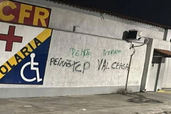 Imagem colorida mostra pichação no muro de delegacia no RJ - Metrópoles