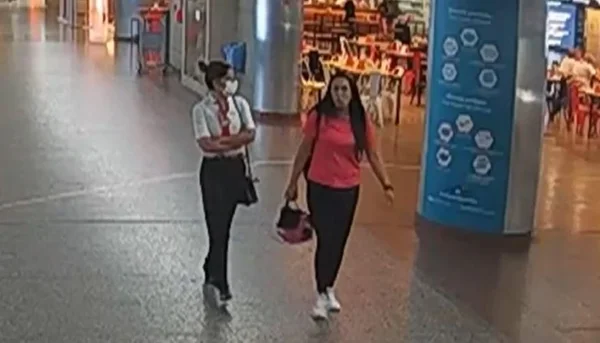 Reprodução colorida de imagems do Aeroporto de Guarulhos com Tamiris Zacharias, funcionária da Gol que usa camisa branca e máscara, e Carolina Pennachiotti, da empresa WFS Orbital, de vermelho, no saguão do aeroporto de Guaruhlos - metrópoles