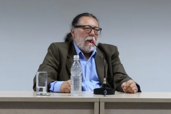 Imagem mostra um homem branco de óculos quadrados e barba branca