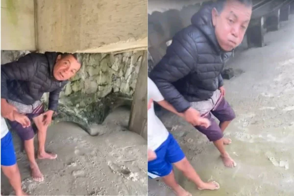 Foto colorida de vídeo em que homem sai segurando criança pelo braço no litoral de São Paulo.