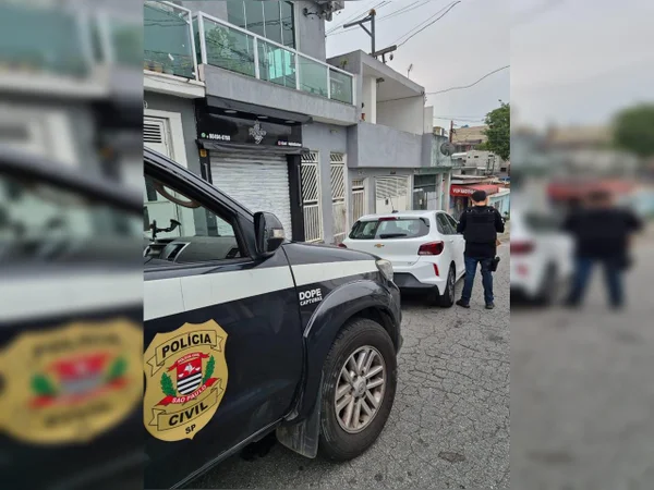 Foto colorida de carro preto com caracterização da Polícia Civil, visto pela lateral