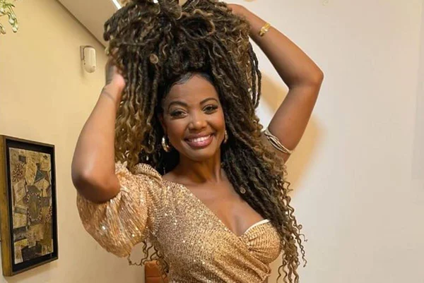 foto de mulher negra com roupa brilhosa sorrindo - metrópoles