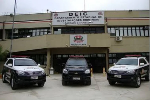 Fachada do Departamento Estadual de Investigações Criminais (DEIC) em São Paulo, com três viaturas policiais paradas na frente - Metrópoles