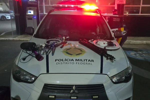 Foto colorida de viatura da PMDF com itens recuperados sobre o capô