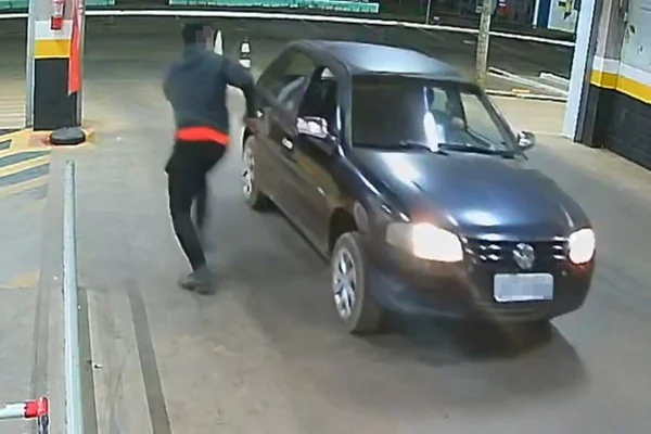 Foto colorida do momento em que o CAC chega em um carro e ameaça o segurança de um supermercado em Brazlândia, no DF