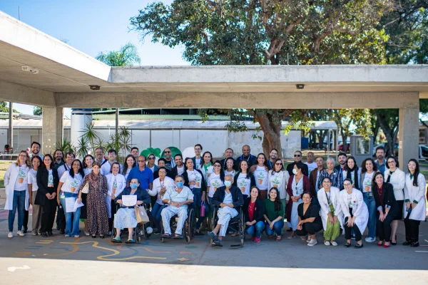 Foto colorida de pacientes e profissionais de saúde do HUB