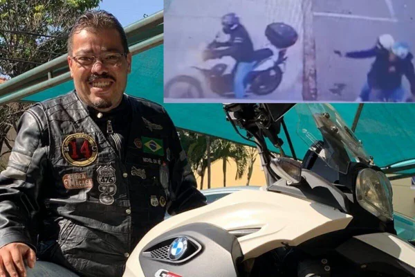 Imagem colorida de homem de cabelo curto, de cavanhaque e óculo, com camiseta azul da seleção brasileira embarcado em moto esportiva branca - Metrópoles
